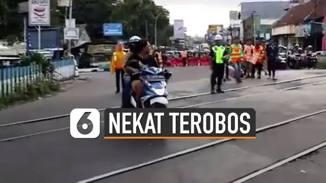 VIDEO: Viral, Pengendara Motor Tak Pakai Helm Nekat Terobos Palang Kereta Api