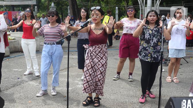 Sejumlah aktivis yang tergabung dalam aliansi perempuan bangkit bernyanyi saat melakukan aksi damai pada Hari Ibu di depan Istana, Jakarta, Minggu (22/12/2019). Dalam aksi tersebut mereka menyuarakan agar menyamakan hak-hak perempuan dan kesejahteraan. (Liputan6.com/Angga Yuniar)