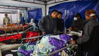 Para korban gempa bumi mendapatkan perawatan di tenda medis darurat di depan Rumah Sakit Ruteng di Ruteng, Manggarai, Nusa Tenggara Timur, Sabtu malam, 15 Agustus 2025. (AFP/ Juni Kriswanto)