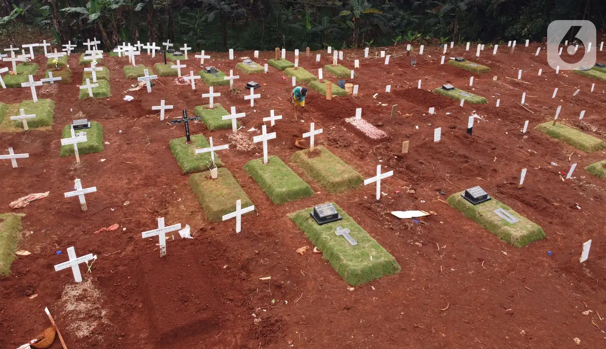Foto udara menggambarkan petugas sedang melakukan perawatan lokasi pemakaman jenazah yang diduga terinfeksi Covid-19 di TPU Pondok Ranggon, Jakarta, Kamis {30/4/2020). Sejumlah makam terlihat mulai dipasangi rumput dan batu nisan. (Liputan6.com/Helmi Fithriansyah)