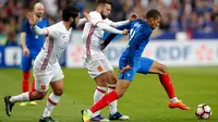 Penyerang Prancis, Kylian Mbappe (kanan) berusaha membawa bola dari kejaran dua pemain Spanyol Isco dan Jordi Alba pada laga persahabatan di Paris, (29/3). Spanyol menang atas Prancis dengan skor 2-0. (AP Photo / Christophe Ena)