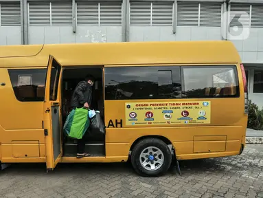 Pasien COVID-19 dibawa ke rumah sakit rujukan menggunakan bus sekolah di Kantor Unit Pelayanan Angkutan Sekolah Dinas Perhubungan DKI Jakarta, Selasa (6/7/2021). Kantor UPAS disulap jadi kamar karantina bagi pasien COVID-19 untuk menambah ketersediaan tempat isolasi. (merdeka.com/Iqbal S. Nugroho)