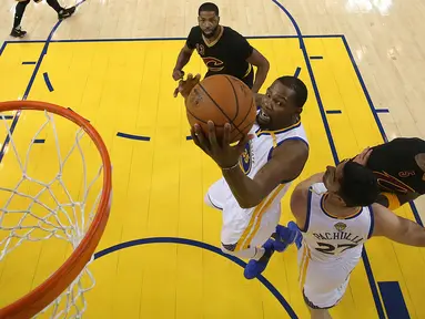 Pemain Golden State Warriors, Kevin Durant mamasukan bola ke dalam ring dalam pertandingan gim kelima Final NBA 2017 di Oakland, California (12/6). Pada pertandingan ini Warriors mengalahkan Cleveland Cavaliers 129-120. (Ezra Shaw/Pool Photo via AP)