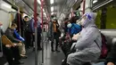 Penumpang mengenakan masker dan pelindung wajah, duduk di kereta di Hong Kong, 23 Februari 2022. Warga Hong Kong semakin kesal dengan desakan pemerintah untuk tetap berpegang pada strategi "nol-COVID" ketika kota itu mencatat rekor jumlah kasus baru lainnya pada hari Rabu. (AP Photo/Vincent Yu)