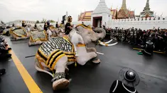 Gajah Ayutthaya duduk ditunggangi pawangnya memberikan penghormatan kepada mendiang Raja Thailand Bhumibol Adulyadej di depan Royal Palace, Bangkok, Thailand (8/11). Gajah merupakan hewan yang dikeramatkan oleh warga Thailand. (Reuters/Jorge Silva)
