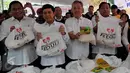 Mendag Rachmat Gobel (kiri) bersama Menpan RB, Yuddy Chrisnandi (kedua kiri) dan pemilik Artha Graha Group Tomy Winata (kedua kanan) menunjukan paket sembako saat program pasar murah di Jakarta, Senin (29/6/2015). (Liputan6.com/Johan Tallo)