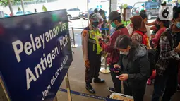 Sejumlah calon penumpang antre untuk menjalani tes swab PCR di Stasiun Pasar Senen, Jakarta, Jumat (24/12/2021). Mulai hari ini, penumpang kereta wajib menunjukkan hasil negatif tes PCR. (Liputan6.com/Faizal Fanani)