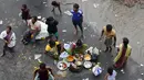 Warga pengungsi memasak makanan mereka di pinggir jalan banjir di Chennai, India, (3/11/2015). Curah hujan terparah dari satu abad telah menyebabkan banjir besar di seluruh negara bagian India Tamil Nadu. (REUTERS/Anindito Mukherjee)