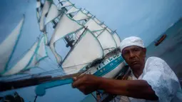 Seorang pria pengikut kepercayaan Candomble Afro-Brasil membawa replika perahu layar untuk ritual perayaan Dewi Laut Yemanja di pulau Itaparica, Brasil (2/2). Perayaan ini bentuk syukur warga pesisir Brasil kepada Dewi Laut. (AP Photo / Eraldo Peres)