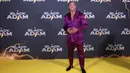 Dwayne Johnson berpose untuk fotografer saat tiba pada pemutaran perdana film 'Black Adam' di London, Inggris, 18 Oktober 2022. Dwayne Johnson memamerkan tubuh kekar bertatonya dengan tidak memakai pakaian di dalam tuksedo yang dia kenakan. (Photo by Vianney Le Caer/Invision/AP)