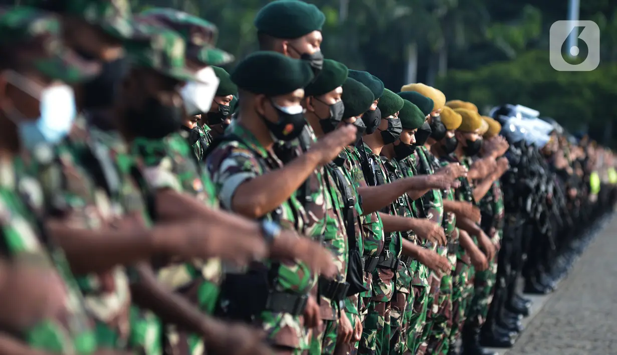 Personel gabungan Polres Jakarta Pusat mengelar apel gelar pasukan pengamanan malam Tahun Baru 2022 di Lapangan Monas, Jakarta, Jumat (31/12/2021). Pengamanan pergantian malam Tahun Baru 2022 sebagai tindak lanjut crowd free night (CFN) yang akan diberlakukan di 11 kawasan. (merdeka.com/Imam Buhori)