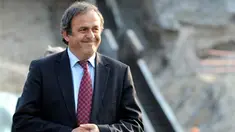 UEFA president Michel Platini smiles as he examines a construction site during a visit on rebuilding Kiev's stadium Olympiysky on April 15, 2009. AFP PHOTO/ SERGEI SUPINSKY 