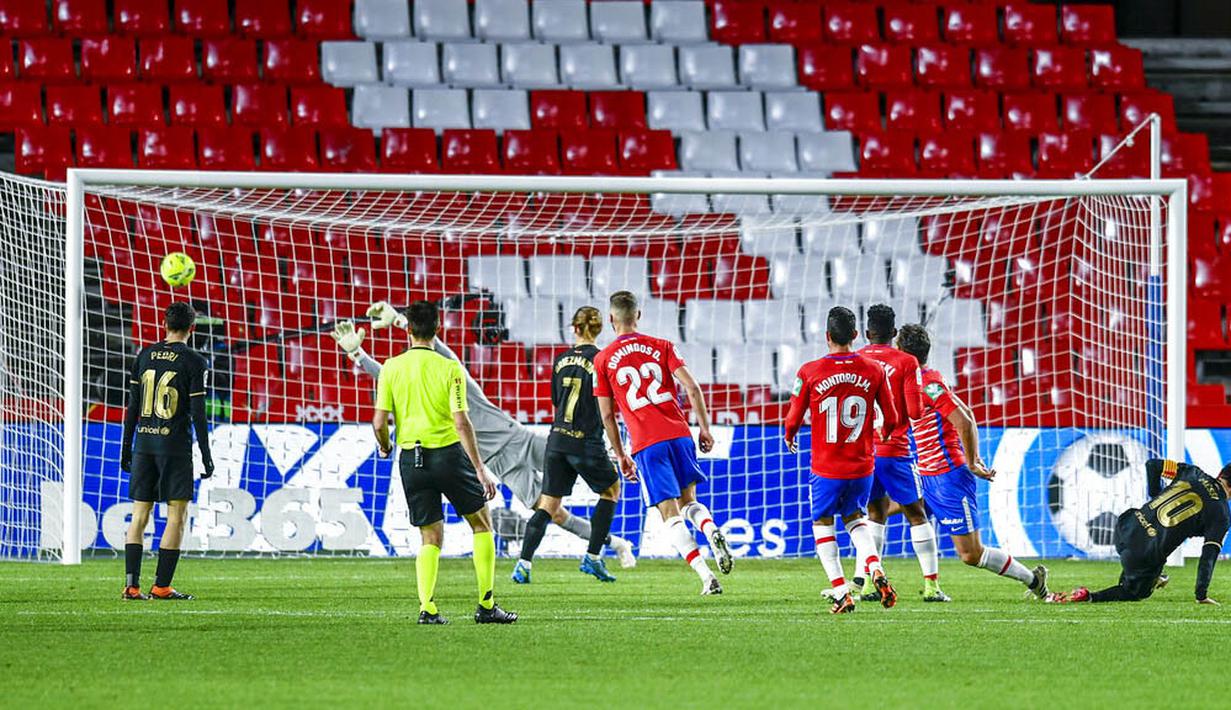 Striker Barcelona, Lionel Messi, mencetak gol ke gawang Granada pada laga Liga Spanyol di Stadion Los Carmenes, Sabtu (9/1/2021). Bracelona menang dengan skor 4-0. (AP/Jose Breton)