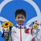 Quan Hongchan,(15) atlet loncat indah asal Tiongkok merebut medali emas Olimpiade Tokyo 2020 lewat nomor papan 10 meter perorangan putri. (Attila KISBENEDEK / AFP)