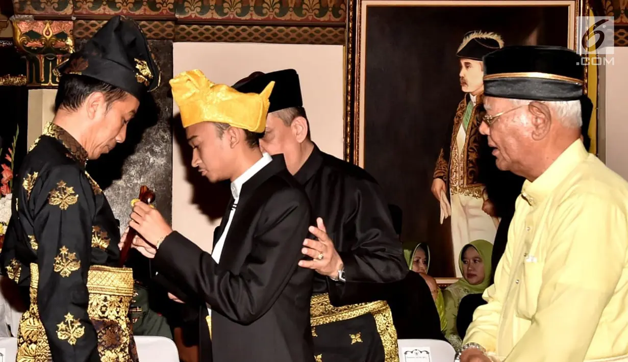 Presiden Joko Widodo menerima penyematan pin dan keris dari Sultan Deli, Tuanku Mahmud Lamantjiji Perkasa Alam saat menerima gelar Tuanku Sri Indera Utama Junjungan Negeri dari Kesultanan Deli di Istana Maimoon, Minggu (6/10). (Liputan6.com/HO/Biropers)