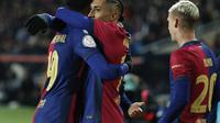 Barcelona's Raphinha, center, celebrates with teammates after scoring his side's third goal during a Spanish Copa del Rey round of 16 soccer match between Barcelona and Real Betis at the Lluis Companys Olympic Stadium in Barcelona, Spain, Wednesday, Jan. 15, 2025. (AP Photo/Joan Monfort)