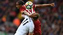 Pemain Liverpool, Joel Matip (kiri) berduel dengan pemain Burnley, Chris Wood pada lanjutan Premier League pekan kelima di Anfield Stadium, Liverpool (16/9/2017). Liverpool bermain imbang 1-1.  (AFP/Paul Ellis)