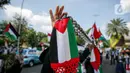 Massa Gerakan Pekerja Muslim Indonesia (GPMI) melakukan aksi solidaritas untuk Palestina di kawasan Thamrin Jakarta, Jumat (28/5/2021). Mereka menyuarakan keprihatinan atas tragedi kemanusiaan di Palestina, serta mewujudkan perdamaian dunia dan kemerdekaan atas Palestina (Liputan6.com/Faizal Fanani)