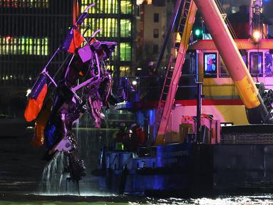 Sebuah helikopter yang jatuh diangkat dari Sungai Hudson yang terletak di antara Manhattan, New York dan tepi pantai New Jersey, Amerika Serikat (AS) pada tanggal 10 April 2025. (Michael M. Santiago/GETTY IMAGES NORTH AMERICA/Getty Images via AFP)