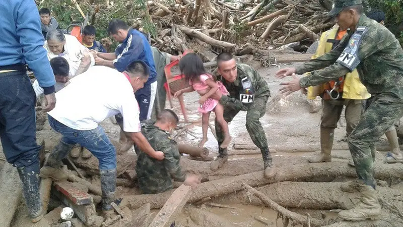 Tentara Nasional Kolombia saat mengevakuasi warga dari musibah banjir bandang dan longsor