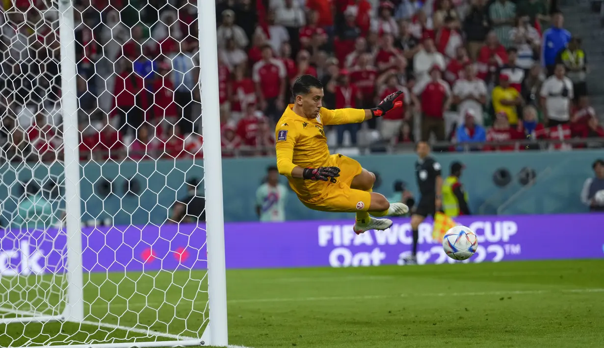 Kiper Tunisia, Aymen Dahmen melakukan penyelamatan saat bertanding melawan Denmark selama pertandingan grup D Piala Dunia 2022 Qatar di Education City Stadium di Al Rayyan, Qatar, Selasa (22/11/2022). Tunisia dan Denmark sama-sama sempat mencetak gol di pertandingan ini. Namun, gol mereka dianulir wasit karena offside. (AP Photo/Manu Fernandez)