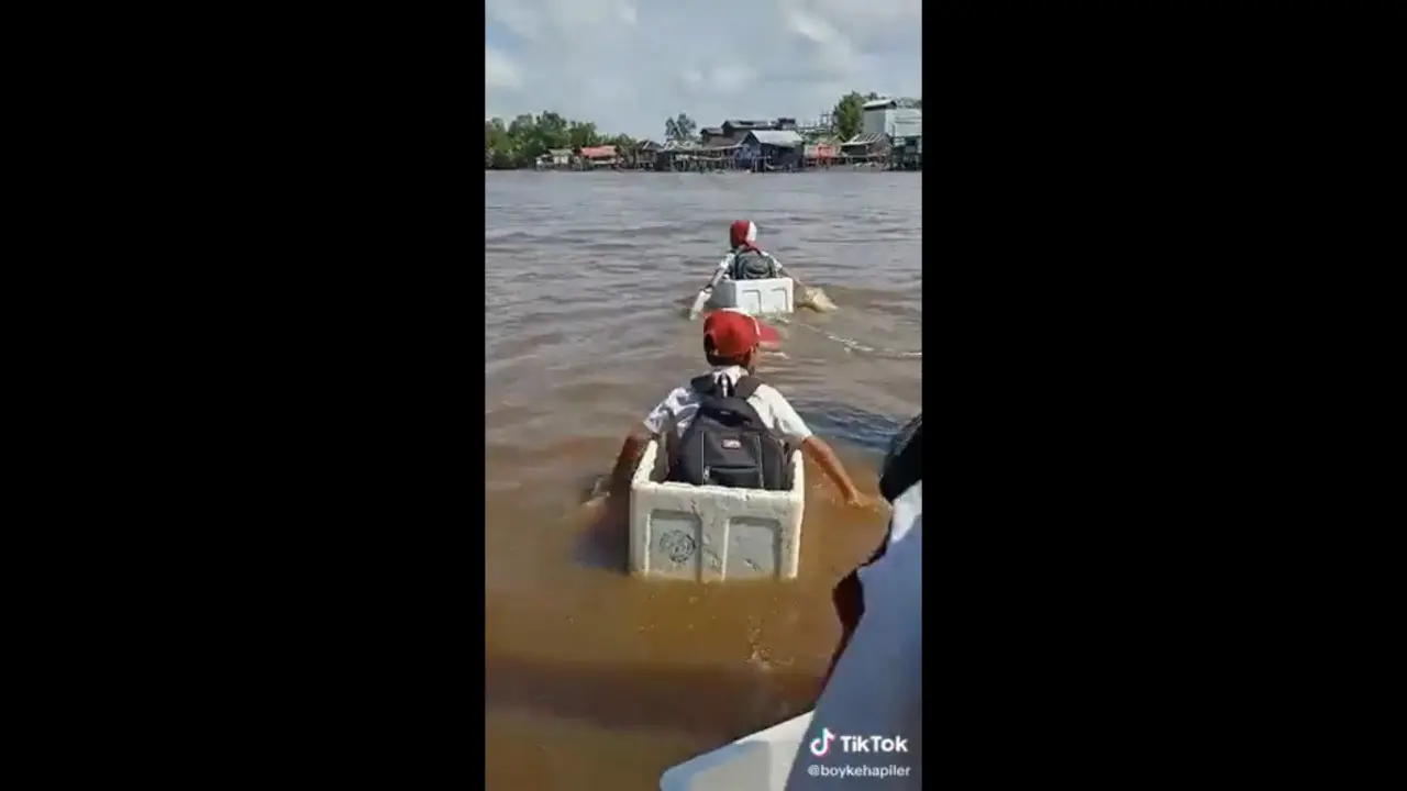 Perjuangan tiga anak SD menuntut ilmu ke sekolah menyebrangi sungai menggunakan boks styrofoam.