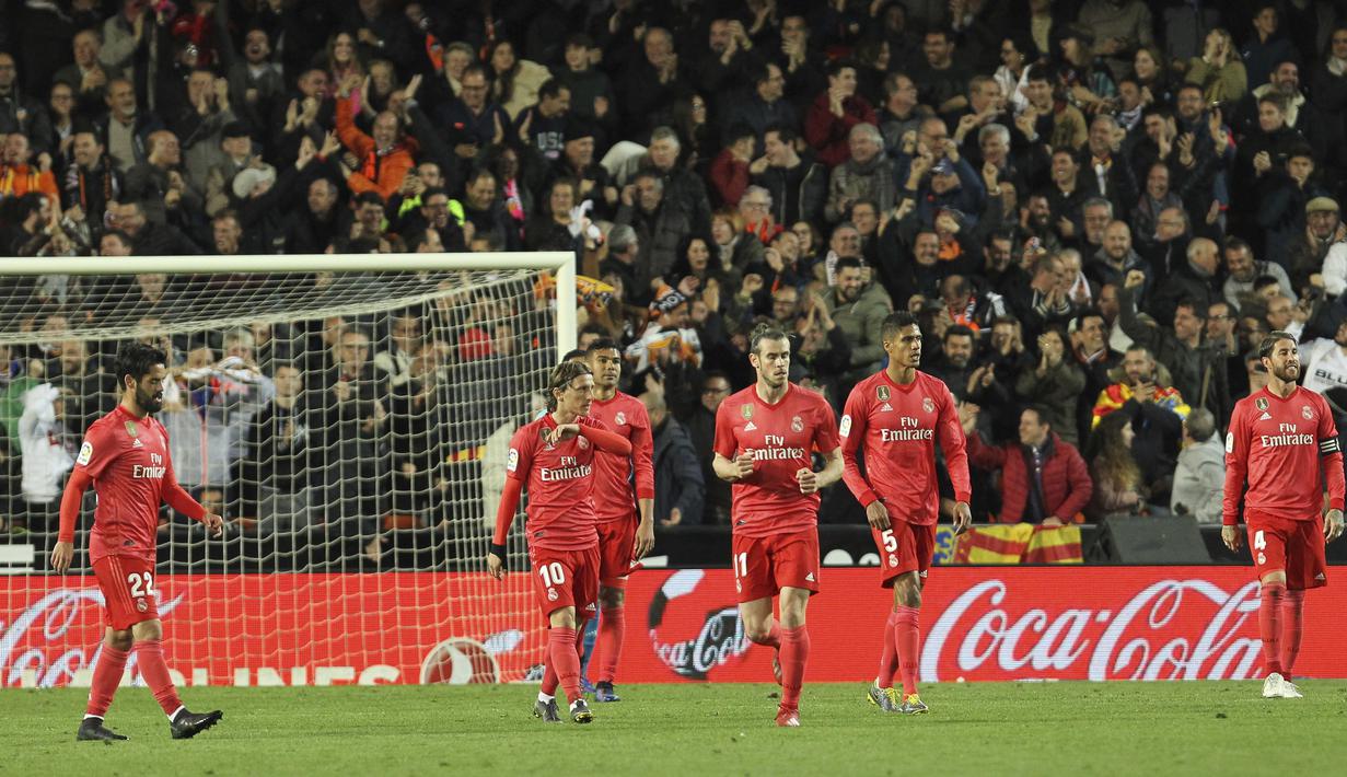 Pemain Real Madrid tampak lesu usai ditaklukkan Valencia pada laga La Liga 2019 di Stadion Mestalla, Rabu (3/4). Valencia menang 2-1 atas Real Madrid. (AP/Alberto Saiz)