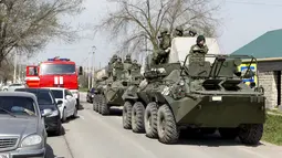 Prajurit angkatan bersenjata Rusia berjaga menggunakan kendaraan lapis baja usai serangan bom bunuh diri di Stavropol, Rusia (11/4). Petugas memblokade jalan masuk ke distrik Novoseletsky, usai serangan tiga bom bunuh diri. (REUTERS/Eduard Korniyenko)