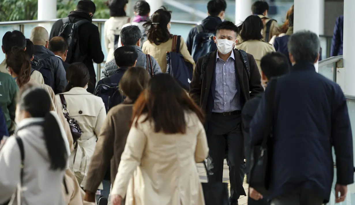 Sebuah lorong stasiun penuh sesak dengan penumpang yang mengenakan masker selama jam sibuk di Stasiun Shinagawa di Tokyo, Senin (22/3/2021). Perdana Menteri Jepang Yoshihide Suga pada Senin mencabut keadaan darurat virus corona di Tokyo dan tiga prefektur lainnya yang tersisa. (AP Photo/Eugene Hoshi