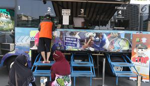 Warga membayar pajak kendaraan bermotor di gerai Samsat Keliling Car Free Day, Jakarta, Minggu (21/10). Agar bisa membayar pajak ini cukup menggunakan STNK dengan nama yang tertera harus sesuai KTP. (Liputan6.com/Angga Yuniar)