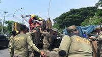 Satpol PP Kota Surabaya menertibkan sebanyak 129 lapak Pedagang Kaki Lima (PKL) yang tersebar di sekitar kaki Jembatan Suramadu, mulai dari sisi barat hingga timur. (Liputan6.com/ Dian Kurniawan)