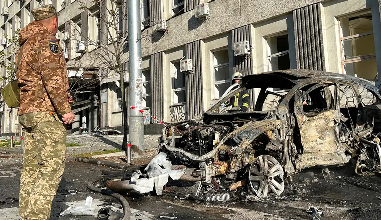 Petugas penyelamat memeriksa lokasi serangan rudal Rusia di Kiev, Ukraina, Senin (10/10/2022). Wali Kota Kiev Vitaliy Klitschko mengatakan ledakan menghantam Distrik Shevchenkivskyy di pusat kota. (AP Photo/Adam Schreck)