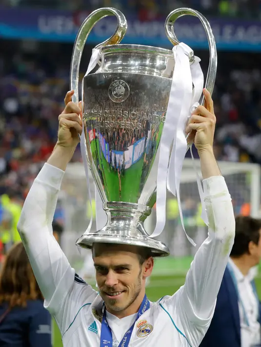 Pemain depan Real Madrid Gareth Bale mengangkat piala saat merayakan kemenangannya usai melawan Liverpool pada pertandingan final Liga Champions di Stadion NSK Olimpiyskiy, Ukraina (26/5). (AP/Efrem Lukatsky)