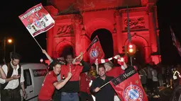 Pendukung Bayern Munchen merayakan kemenangan timnya meraih gelar juara Liga Champions setelah mengalahkan PSG pada final dimainkan di stadion Luz di Lisbon, Portugal di Munich, Jerman ,Minggu, (23/8/2020). Munchen menang 1-0 atas PSG.  (Felix H'rhager / DPA via AP)