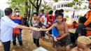 Sejumlah karyawan BRI membagikan paket makanan siap saji kepada masyarakat terdampak banjir di Abepura, Jayapura, Papua. Penyaluran bantuan dilakukan secara bertahap dengan memprioritaskan masyarakat yang terdampak lebih parah. (Liputan6.com/HO/Humas BRI)