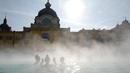 Orang-orang menikmati air hangat di kolam relaksasi Szechenyi, di Budapest, Hongaria pada 15 Februari 2019. Szechenyi Thermal Bath adalah salah satu lokasi pemandian umum tertua dan terbesar di Budapest. (VALERY HACHE / AFP)