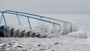 Sebuah tangga tertutup salju di pantai Danau Balaton di Fonyod, Hungaria (26/2). Cuaca ekstrem dengan angin kencang melanda sebagian besar wilayah Hungaria. (Gyorgy Varga / MTI via AP)