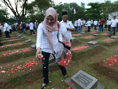 Aktivis Rembuk Nasional Aktivis (RNA) 98 menaburkan bunga di makam korban kerusuhan 98 di TPU Pondok Rangon, Jakarta, Selasa (14/5/2019). 21 tahun tragedi Mei 98 mengisahkan kenangan pilu bagi keluarga korban di mana saat itu diperkirakan 1.217 orang tewas dalam kerusuhan. (merdeka.com/Imam Buhori)