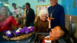 Divaldo Aguiar menjulurkan lidah saat difoto didalam peti matinya selama festival Burial of Pachencho di Santiago de Las Vegas, Kuba (5/2). Dalam tradisi ini akan dipilih beberapa orang sukarelawan untuk dikubur hidup-hidup. (AP Photo/Ramon Espinosa)