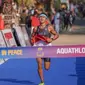 atlet aquathlon putra Indonesia, Rashif Amila Yaqin, berhasil menjadi yang tercepat di nomor individual aquathlon putra dan menjadi peraih medali emas pertama Indonesia di SEA Games 2023. (Bola.com/Dok: NOC Indonesia/Rizki Fitrianto)