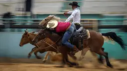 Koboi Kuba berkompetisi dalam pertandingan gulat sapi di rodeo adil Peternak Boyeros selama Pameran Pertanian Internasional Fiagrop 2022 di Havana, Kuba (8/4/2022). Rodeo di Kuba adalah tradisi yang berusia lebih dari dua abad. (AP Photo/Ramon Espinosa)