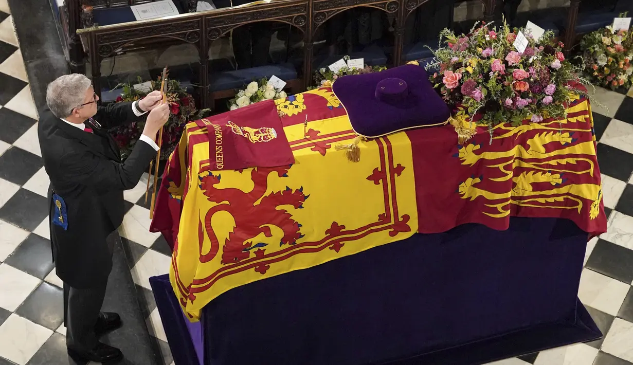Lord Chamberlain secara seremonial memecahkan Tongkat di depan peti mati jenazah Ratu Elizabeth II Kapel St George di Kastil Windsor, Inggris, Senin 19 September 2022. (Jonathan Brady/Pool Photo via AP)