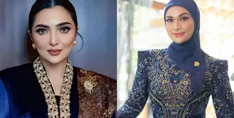 Ashanty tampil dengan kebaya biru navy panjang model velvet. Kebaya yang dibuat oleh Windy Savosa Couture ini memiliki bordiran di bagian depan. Melengkapi tampilannya dengan selendang batik senada dengan bawahan. Dan mengenakan bros di selendangnya. [@ashanty_ash].
