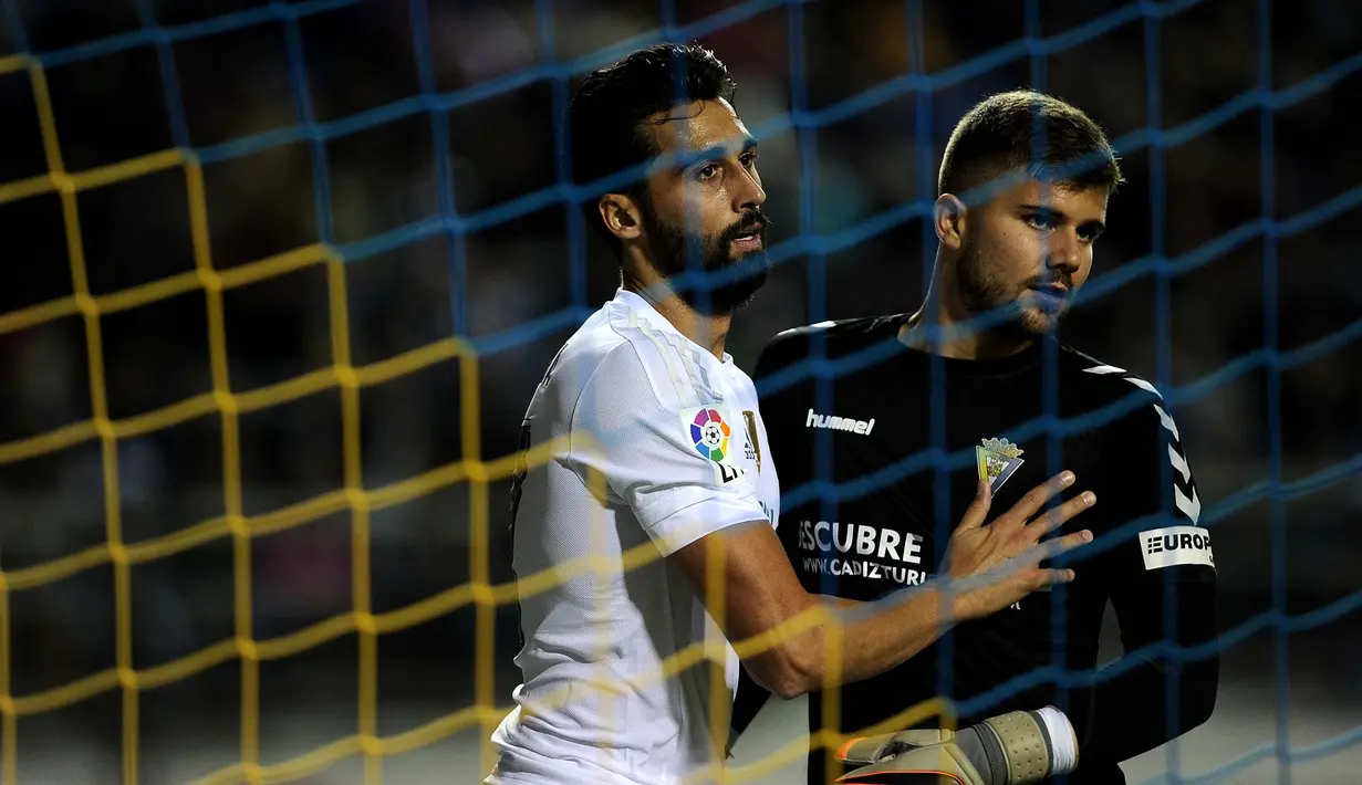 Pemain Real Madrid,  Alvaro Arbeloa (kiri) berduel dengan kiper Cadiz, Pol Balleste pada laga Copa del Rey (King's Cup) di Stadion Ramon de Carranza, Cadiz, Kamis (3/12/2015) dini hari WIB. (AFP Photo/Cristina Quicler) 