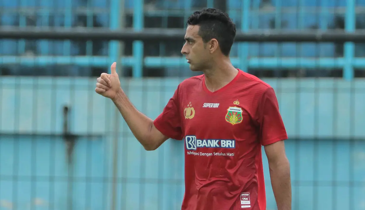 Bek Bhayangkara FC, Otavio Dutra, memberikan kode kepada rekan-rekannya saat melawan PS TNI pada laga Piala Presiden 2017 di Stadion Kanjuruhan, Malang, Sabtu (11/7/2017). Bhayangkara FC menang 2-1 atas PS TNI.(Bola.com/Reza Bachtiar)