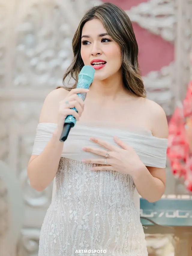 Raisa saat nyanyi di kondangan pakai dress putih senada dengan antingnya. [@artmospoto]