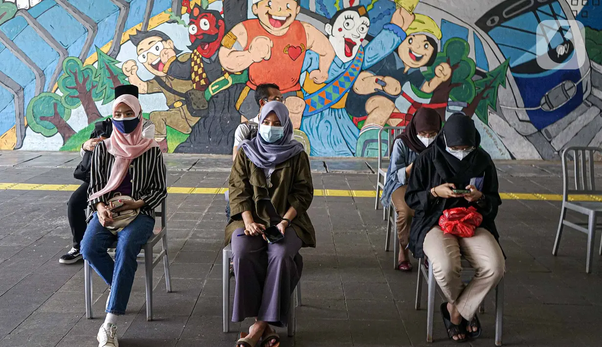 Warga menunggu saat menjalani vaksinasi COVID-19 Sinovac di Terowongan Kendal, Jakarta Pusat, Jumat (30/7/2021). Sebanyak 600 dosis disiapkan untuk masyarakat pengguna transportasi publik di kawasan integrasi Commuter Line, kereta bandara, dan Transjakarta tersebut. (Liputan6.com/Faizal Fanani)