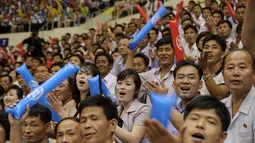 Fans Korea Utara saat menonton pertandingan antara Korea Utara dan Korea Selatan di Stadion Indoor Ryugyong Chung Ju-Yung, Pyongyang (5/7). 50 pemain pria dan wanita dari Korsel tiba di ibukota Utara 3 Juli untuk laga persahabatan. (AFP Photo/Kim Won-Jin)