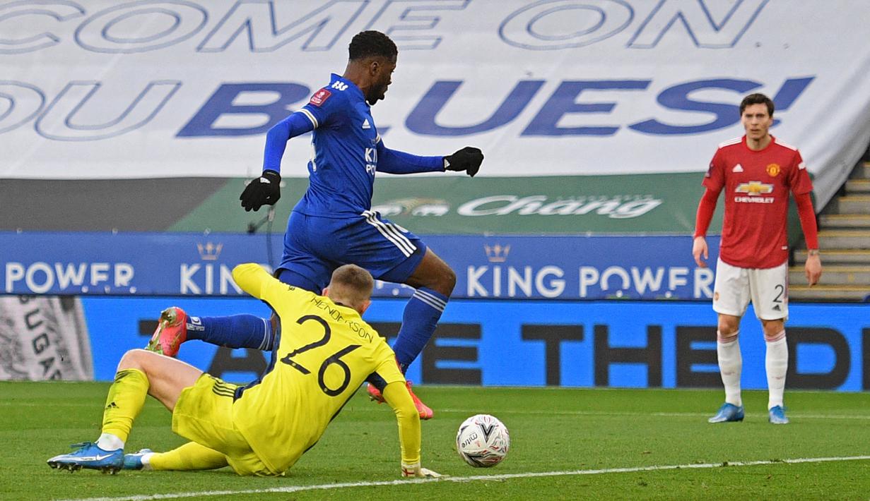 Striker Leicester City, Kelechi Iheanacho mengecoh kiper Manchester United, Dean Henderson untuk mencetak gol pertama timnya dalam laga perempatfinal Piala FA 2020/2021 di King Power Stadium, Minggu (21/3/2021). Leicester menang 3-1 atas Manchester United. (AFP/Oli Scarff/Pool)