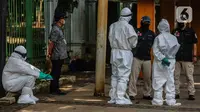 Tim medis menggunakan alat pelindung diri (APD) setelah memeriksa kondisi orang yang tergeletak di Jalan Merdeka Barat, Jakarta, Kamis (23/4/2020). Usai dilakukan pemeriksaan oleh tim medis, tunawisma tersebut dinyatakan negatif covid-19. (Liputan6.com/Faizal Fanani)